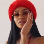 Saweetie press photo with red hat