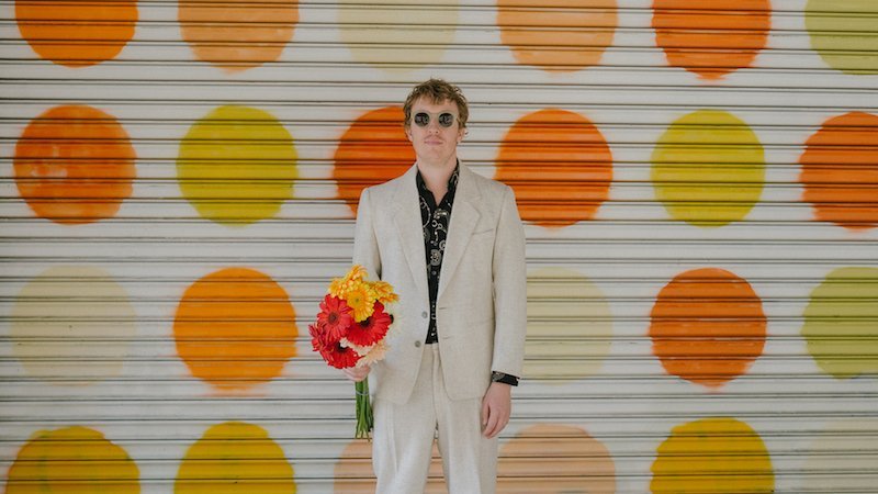 Evan Myall press photo with flowers