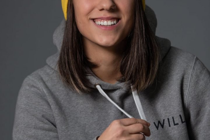 Andrea press photo in the studio wearing a yellow beanie
