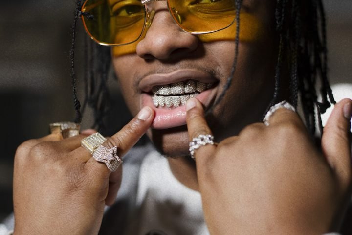 Poundz press photo showing his mouth jewelry (close up shot)