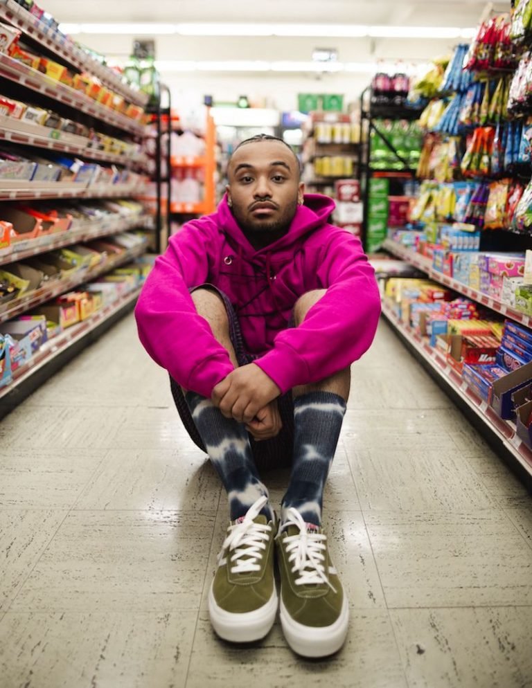 Daniyel press photo sitting in an aisle at a grocery store