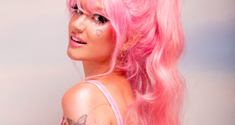 Peach PRC press photo wearing pink hair and pink and white outfit