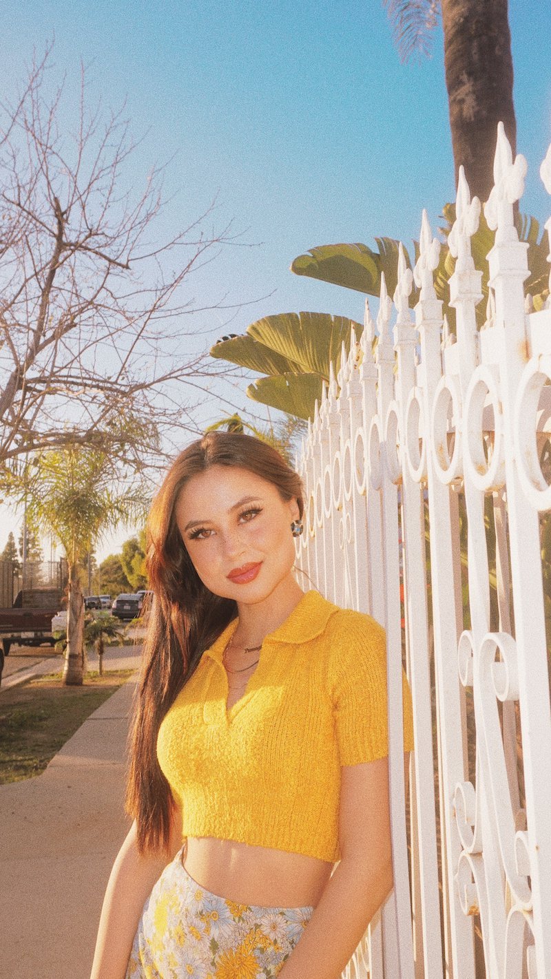 tiger lily press photo outside wearing a yellow summer outfit 