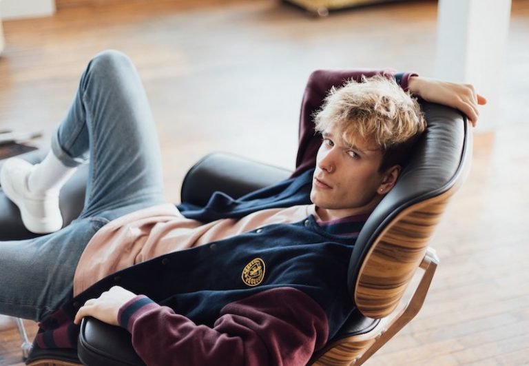 Dominik Klein press photo seated in a comfortable chair