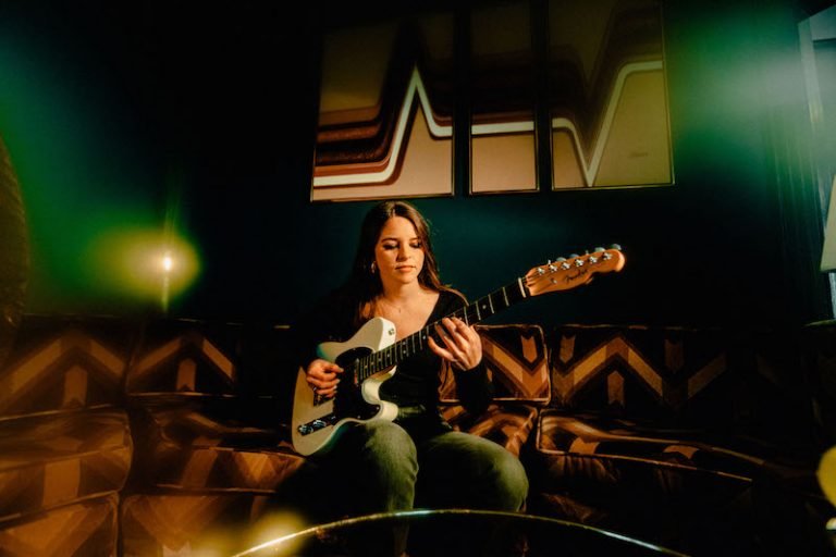 Shannon Lauren Callihan press photo playing a guitar
