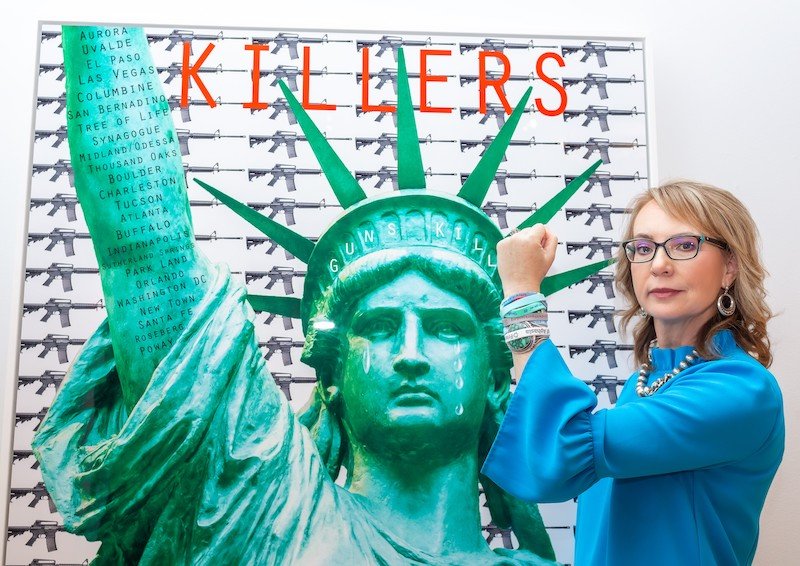 Gabby Giffors with artwork Guns Kill by Bonnie Lautenberg